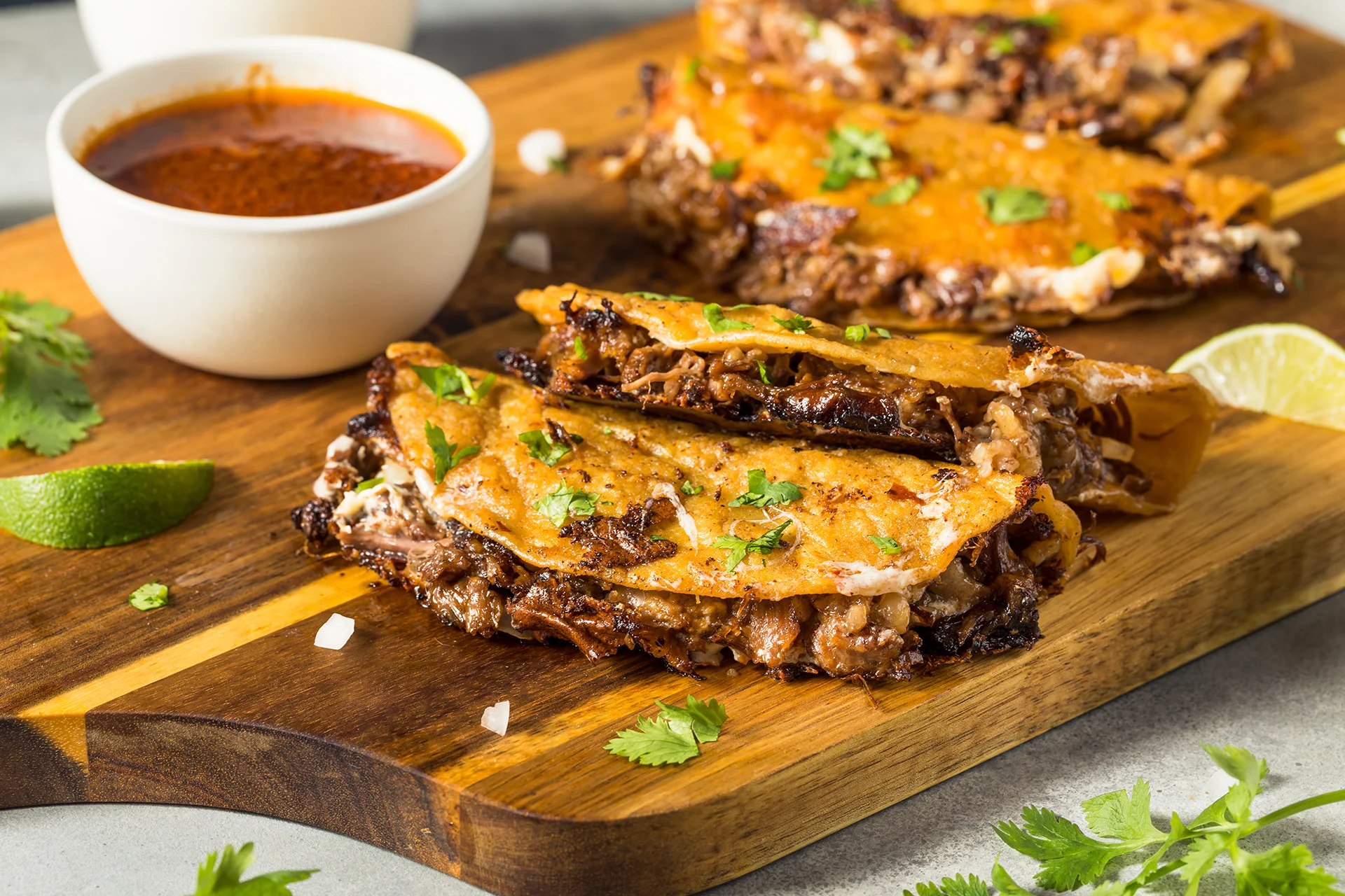 Authentic birria tacos with rich consomme